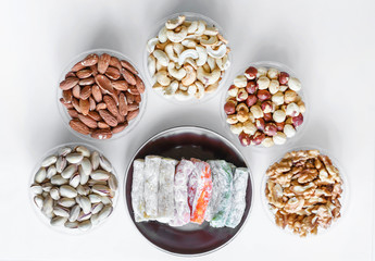 Traditional Turkish Delight. Oriental dessert on a  plate. Isolated on white background. Eastern delicacy sweets. Healthy food mix assortment. Collection of different for image close up top view