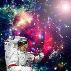 Obraz na płótnie Canvas Astronaut gives thumbs-up against outer space, galaxies and stars. The elements of this image furnished by NASA.