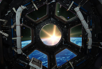 Fascinating sunrise on earth. Spaceship window view. Elements of this image furnished by NASA.
