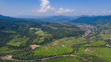 Aerial view of the Carpathian mountains. Natural background with geometric pattern - beige and red...