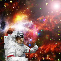 Obraz na płótnie Canvas Astronaut gives thumbs-up against outer space, galaxies and stars. The elements of this image furnished by NASA.
