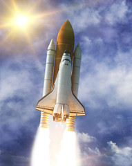 Obraz premium Sunflare and rocket. The elements of this image furnished by NASA.