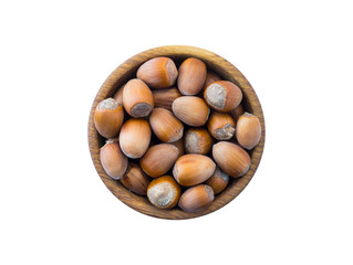 Hazelnuts isolated on white background. Hazelnuts in a bowl with copy space for text. Hazelnut close-up. Top view.