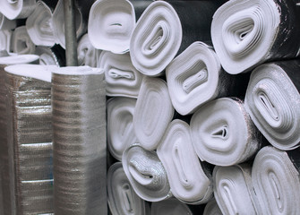 Many silver large rolls of foil insulation