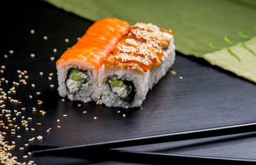 Japanese sushi and rolls on a black background