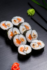 Japanese sushi and rolls on a black background