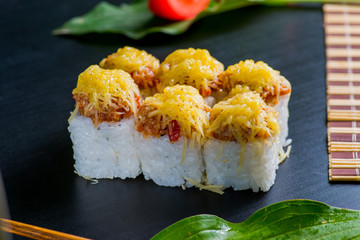 Japanese sushi and rolls on a black background