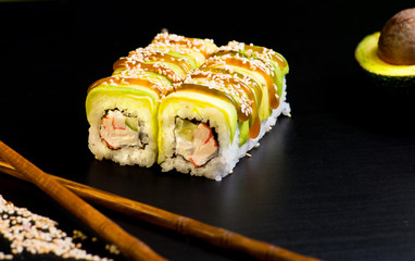 Japanese sushi and rolls on a black background
