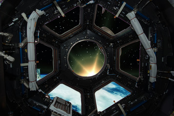 Fascinating sunrise on earth. Spaceship window view. Elements of this image furnished by NASA.