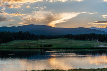 Sunset over a small Lake in the Colorado Rocky Mountains, known as Los Lagos Reservoir Number three. Near Kelly Dahl Campground and the Town of Nederland, CO.