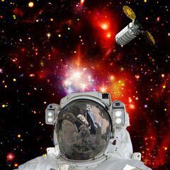 Astronaut posing against galaxies and stars. Outer space. The elements of this image furnished by...