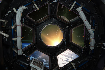 Fascinating sunrise on earth. Spaceship window view. Elements of this image furnished by NASA.