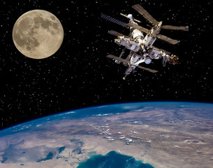 Obraz na płótnie Canvas Moon and space station flying near. The elements of this image furnished by NASA.