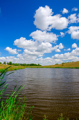 Sunny summer landscape with river and fields