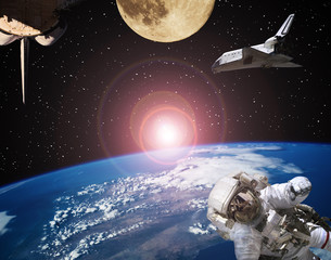 Astronaut, spaceships and moon. Sunrise on the backdrop. The elements of this image furnished by...