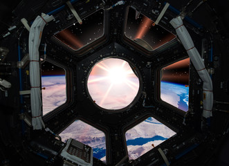 Earth in window of spaceship. Elements of this image furnished by NASA.