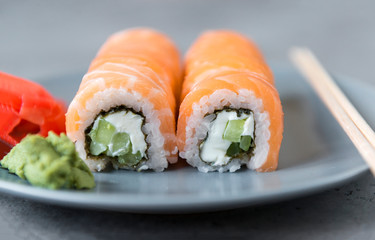 Japanese rolls with salmon and soft cheese on a plate