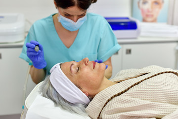 Skin care. Woman receiving facial beauty treatment. Facial therapy. Anti-aging procedures.
