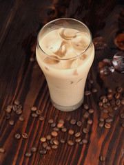 Milk with coffee and ice cubes. Cold summer drink.
