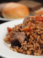 Rice with Vegetables and Meat in a plate on wooden table