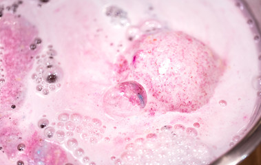 Fototapeta premium The bright bath bomb dissolves in water .