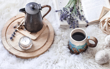 Cozy still life with a kettle and a Cup of hot drink