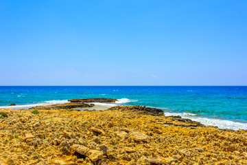  pristine seascapes with crystal clear blue water and yellow rocks in Ayia Napa, Cyprus