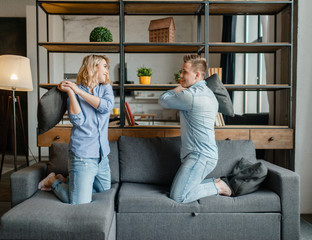 Funny love couple staged fights on the pillows