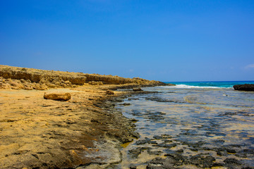  pristine seascapes with crystal clear blue water and yellow rocks in Ayia Napa, Cyprus