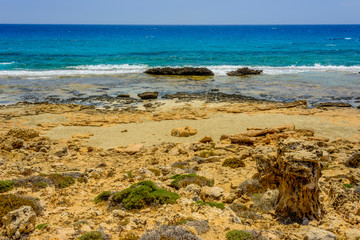  pristine seascapes with crystal clear blue water and yellow rocks in Ayia Napa, Cyprus