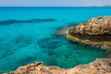  pristine seascapes with crystal clear blue water and yellow rocks in Ayia Napa, Cyprus