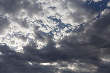 Fototapeta premium Cloudy beautiful sky. The sun hides behind the clouds. Sunny day.
