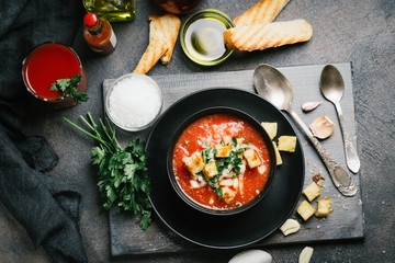 Traditional spanish gazpacho made from fresh farm produce on a dark background. top view