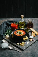 Traditional spanish gazpacho made from fresh farm produce on a dark background. top view