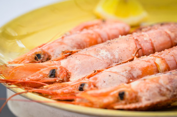 grilled shrimps with lemon juice and olive oil - fresh seafood dish 