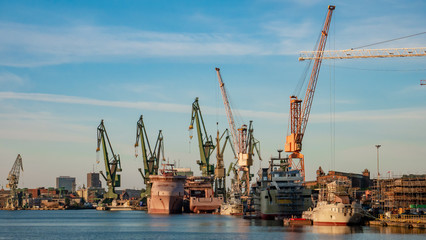 Fototapeta na wymiar View of the shipyard with historical cranes and ships in the industrial part of the city Gdansk/Poland.