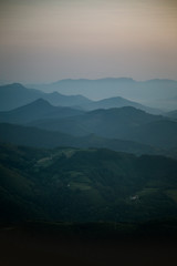 Mountain layers on a foggy evening sunset