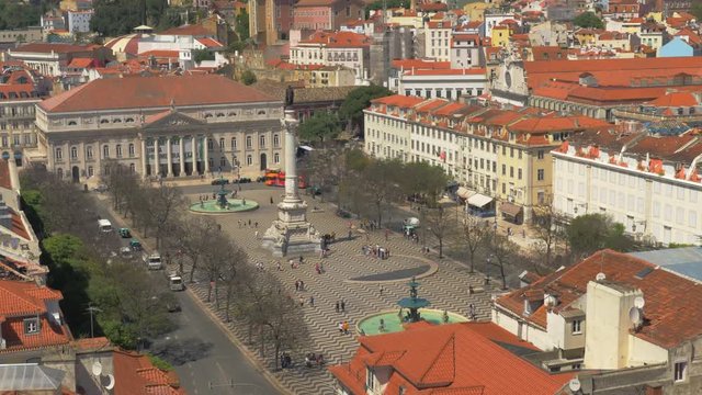 Cityscape of Lisbon in Portugal. Scene with people walking at Rossio Square with the Column of Pedro IV in the middle
