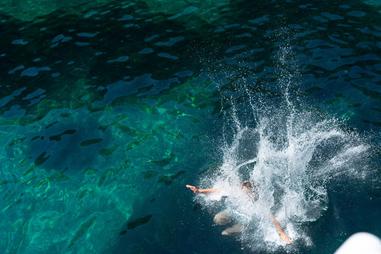 High Angle View On The Splash In The Sea After Man Woman Jump In Water Ocean In Summer Day Lake