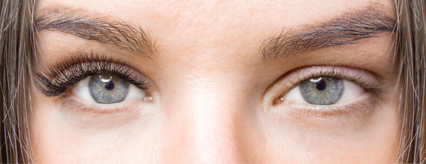 Before and after eyelash extension procedure. Woman Eyes with Long false Eyelashes. Close up macro shot - Beauty and fashion concept.
