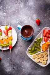 Fototapeta na wymiar Sweet chocolate fondue with fruits