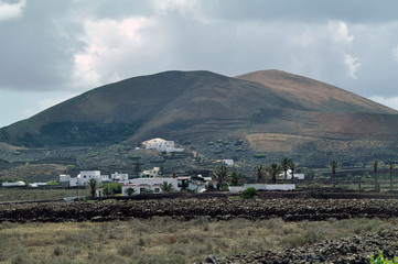 Traditional white town in mountains on volcanic Lanzarote Island, Canary, Spain