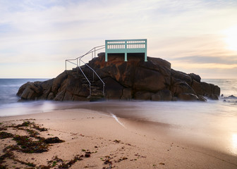 View point or gazebo over the rocks on a beach in Vila do Conde, Portugal, at sunset.