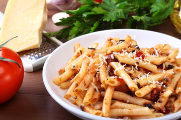 Spicy pasta penne bolognese with vegetables, chili and cheese in tomato sauce.