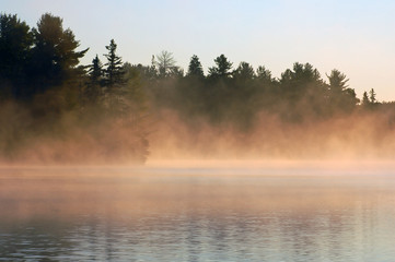 Obraz na płótnie Canvas Sunrise and mist in beautiful lake in Algonquin Park