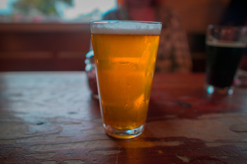 golden ale beer with a person in the background