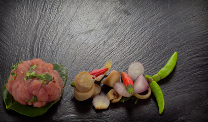 Red meat on a black stone board