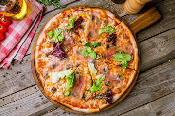 Pizza with Parma ham on the board