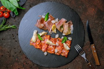 slicing of different meat on black stone