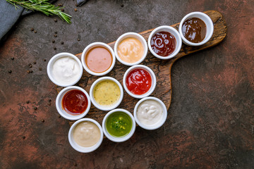 assorted sauces top view on rustic concrete background